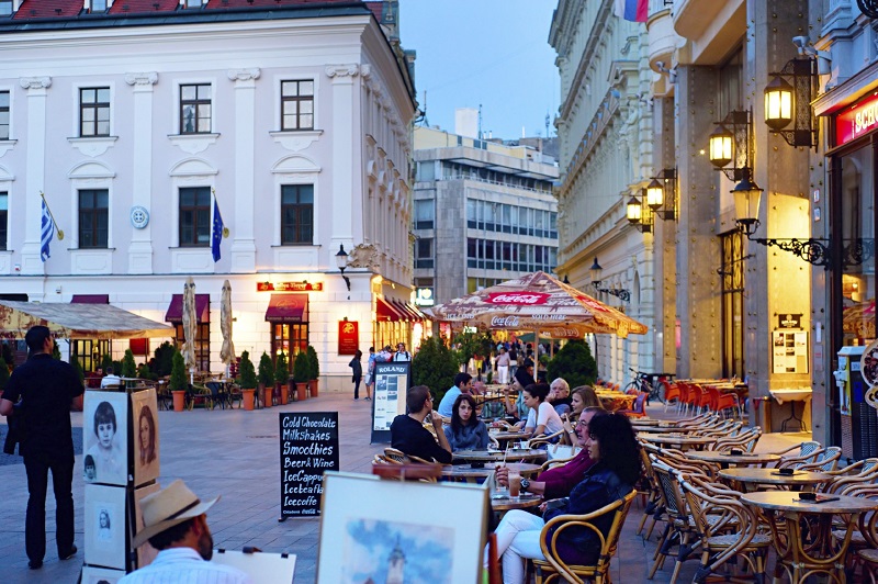 Bratislava, Slovakia - August 31, 2013: Tourists are chilling in cafe on Main Square in city downtown in Bratislava. Recently the biggest in slovakia internatioanl cha-cha contest took place here, on Main Square.