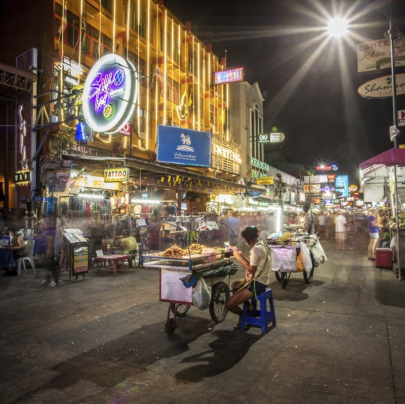 BANGKOK - APRIL 21, 2014: Street food vendor and tourist shops on Khao San Road on April 21, 2014 in Bangkok, Thailand. Khao San Road is a famous low budget hotels and guesthouses area in Bangkok.