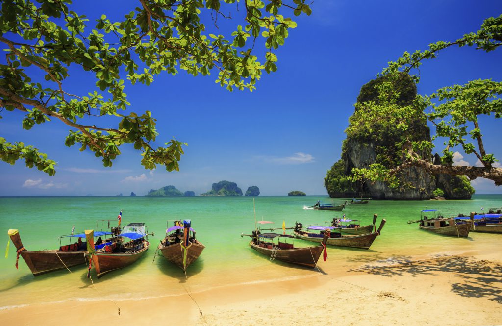 Traditional longtail boat at sunset on tropical island, Thailand