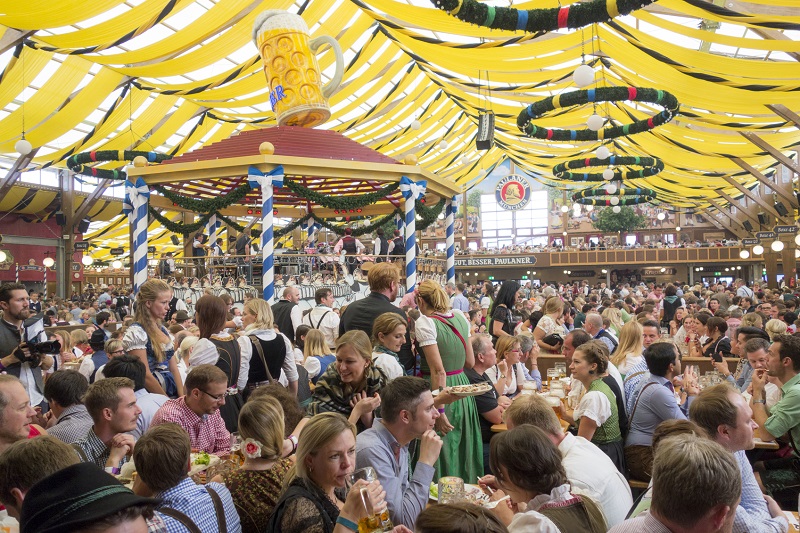 Munich, Germany - September 20, 2015: Many People are sitting in the beer tent at the Octoberfest in Munich and having fun.The Oktoberfest is the largest fair in the world and is held annually in Munich.