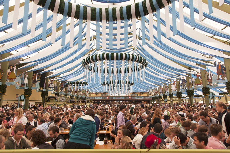 "Munich, Germany - September 22, 2012: People are waiting for the serve or order at the festival hall in SpatenBrau - Festivalhall at the early morning in Munich, Germany"