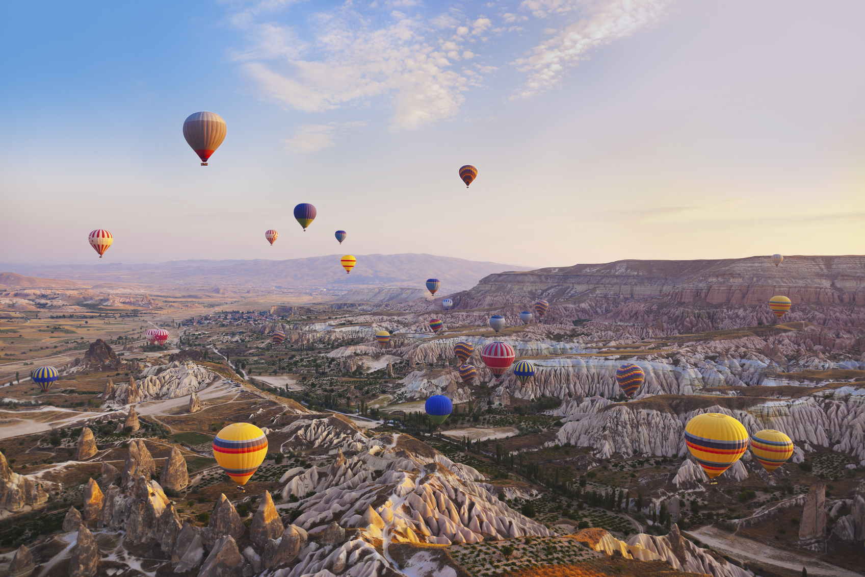 Hot air balloon flying over rock landscape at Cappadocia Turkey