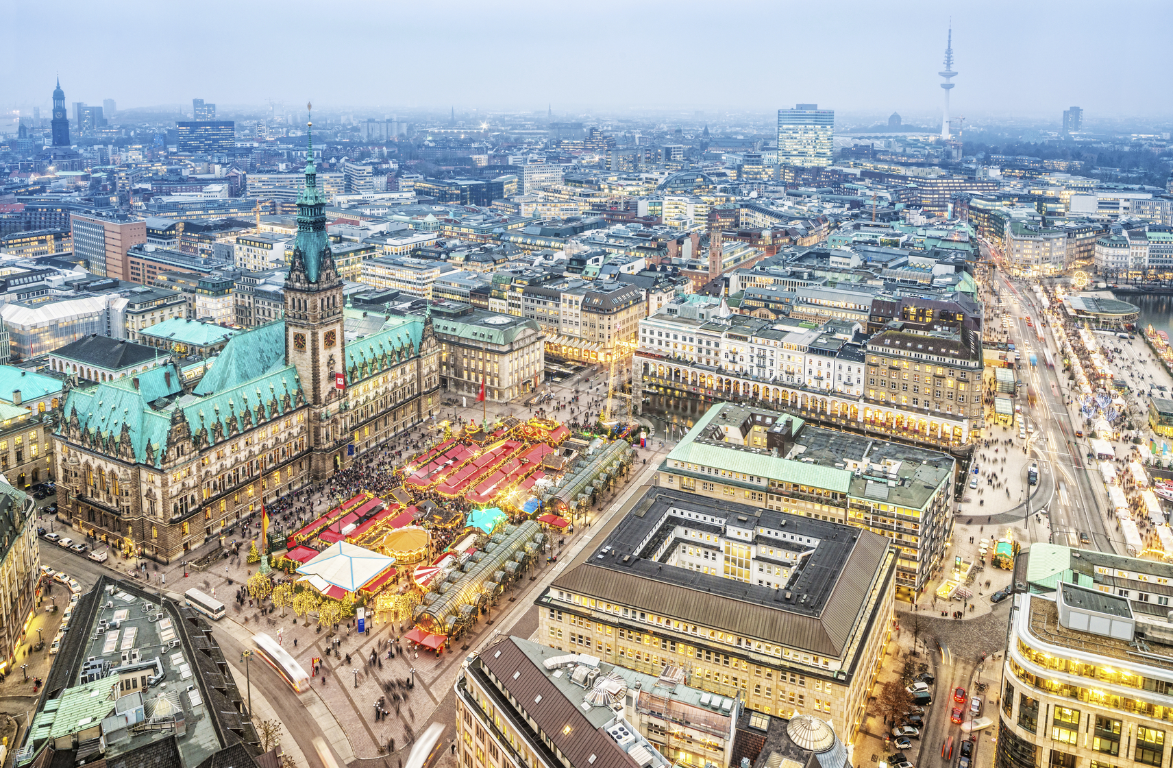Aerial view on the winterly illuminated city of Hamburg. Christmas decoration, illuminated buildings and streets, the christmas market at the town hall.